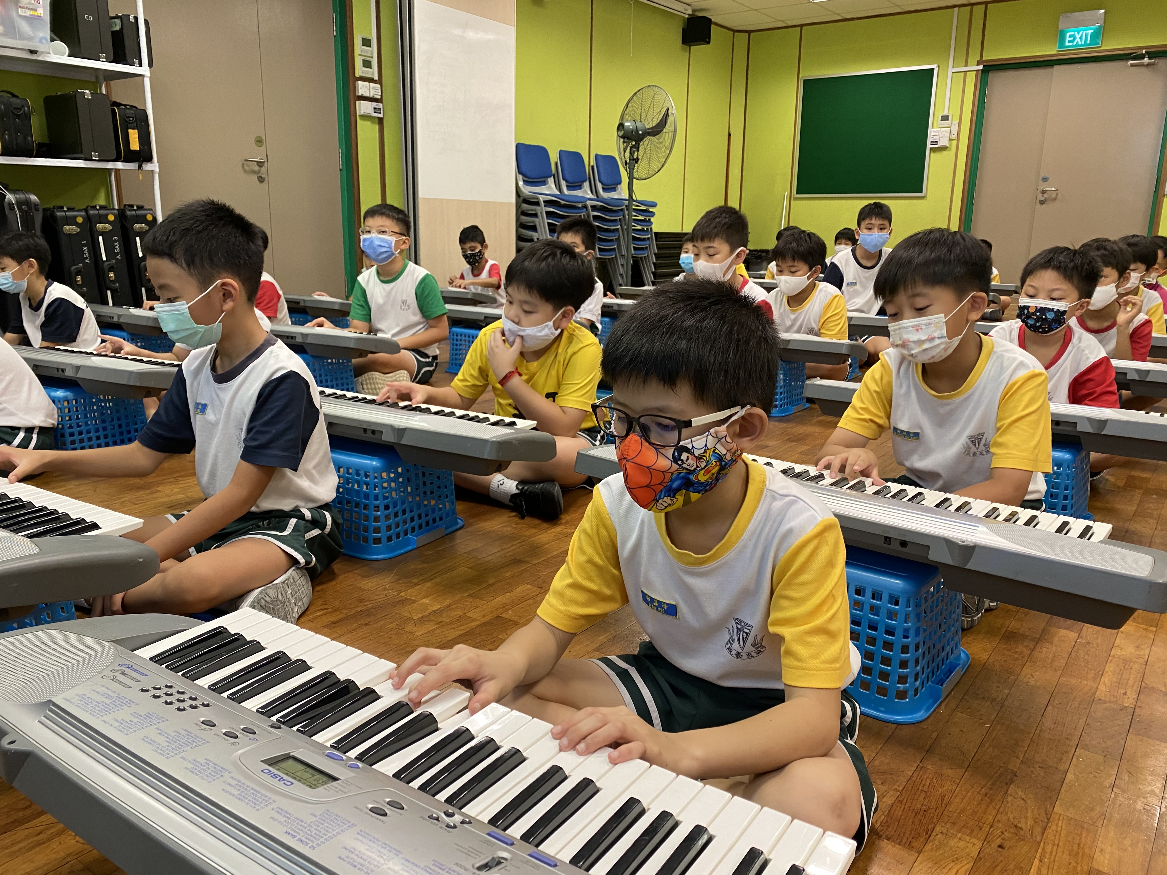 Primary 3 pupils learning to play the keyboard